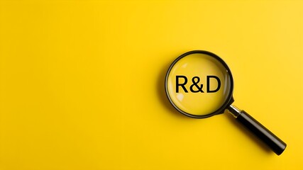 R&D, Research and Development, magnifying glass on a yellow background, close-up photography with text R&D, innovation 