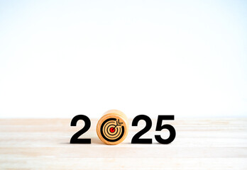 Wall Mural - 2025 Happy new year background. Target icon on round wooden block with 2025 calendar numbers, isolated on wood table, white background with copy space. Business goal and objective plan concept banner.