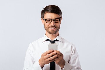 Poster - Business Chat. Smiling Man Texting On Cellphone Over White Studio Background. Empty Space