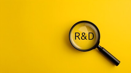 R&D, Research and Development, magnifying glass on a yellow background, close-up photography with text R&D, innovation 