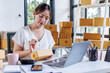 © David - Portrait business woman smile and use tablet checking information on parcel shipping box before send to customer. Entrepreneur small business working at home. SME business online marketing.