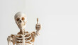 © Duka Mer - A skeleton giving a thumbs up gesture, isolated on a white background.