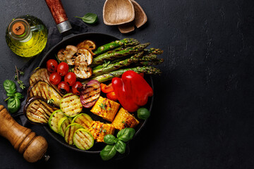 Wall Mural - Assorted grilled vegetables on a frying pan, showcasing a colorful and healthy meal