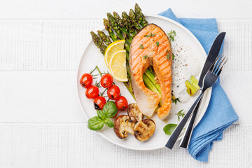 Wall Mural - Grilled salmon steak over grilled asparagus, a delicious and healthy meal