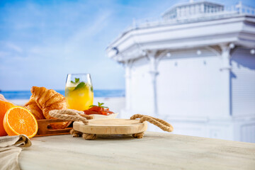 Poster - 
 Summer continental breakfast on a beach. Croissants, jam and fruit on a wooden table. Summer table background for montage product display. Copy space for food and drink and products.
