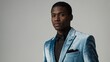 © Arceli - Young man wearing grooms velvet suit model posing on plain white background
