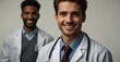 © Hashim - Smiling young doctor with stethoscope, white background