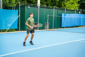 Professional male tennis player playing the tennis on outside court