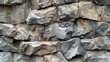 © Pixel - Close-up of a rough, gray and brown stone wall texture.