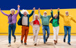 © Westend61 - Carefree senior friends holding hands with arms raised and running on footpath
