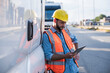 © Westend61 - Logistics worker using tablet PC standing by truck