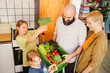 © Westend61 - Happy family with crate of fresh vegetables at home