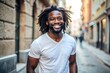 © nilawan - Happy young man with dreadlocks smiling in the city.