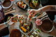 © Nander - Person grabbing a fancy taco from a wooden plate in a fancy restaurant