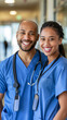 © Olga Nevskaya - Smiling Medical Professionals in Blue Scrubs Standing Together Indoors