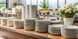 © Sujid - Clean and modern catering setup with stacks of plates and serving dishes, catering, event, buffet, restaurant, cafe