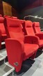 © peacehunter - Red Theater Seats in a Modern Cinema Hall with Comfortable Armrests and Elevated Seating Arrangement