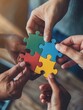 © PapatoniC - Close up of diverse business people joining colorful puzzle pieces. Business and teamwork concept