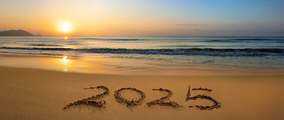 Wall Mural - 2025 written in the golden sands of a sun-kissed beach.