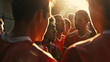 © VK Studio - A group of focused soccer players huddle and listen intently to their coach during a sunset training session.