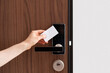 © brizmaker - Hand using key card to unlock door in hotel room or apartment