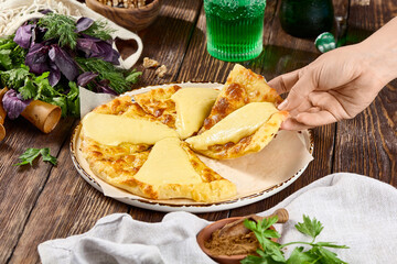 Wall Mural - Georgian Khachapuri with Imeretian Cheese on Rustic Wooden Background