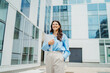 © Dusan - One beautiful young successful business woman going to work at business office modern building while holding papers and wearing glasses