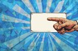 © Georgii - Comic book style hand pointing to blank sign against a shattered blue background