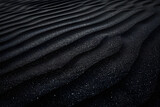 Black Sand dune. Black Sand beach macro photography. Background, texture, wave pattern of oceanic sand on the beach, black. Texture of beach sand. Black beach.