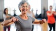 © Prosanta - A middle-aged woman, with a serene smile, taught a white-background group fitness class.