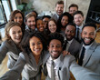 © modestil - Selfie of a happy small group of business people with different ethnicity