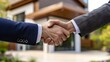 © carballo - handshake with house in the background, buying a house
