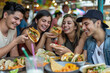 © WETDREAM - A group of people are eating food, including tacos, at a table