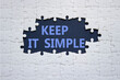 © Natallia - Keep it Simple symbol. Concept words Keep it Simple on white puzzle. Beautiful deep blue background. Business and Keep it Simple concept. Copy space.