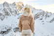 © makedonski2015 - A woman traveler stands against the backdrop of snowy mountains