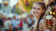 © Julia Zarubina - beautiful young woman in traditional German costume holds a mug of beer against the background of the Oktoberfest festival in Germany, Munich, Bavaria, drink, national, autumn, October, fair, alcohol