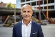 © NikoG - Smiling portrait of a middle aged male engineer at construction site