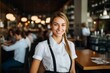 © NikoG - Portrait of a smiling young female waitress in restaurant