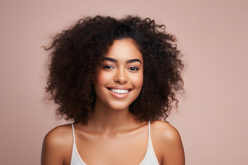 Canvas Print - portrait of a beautiful woman with curly hair smiling and happy over light pink background