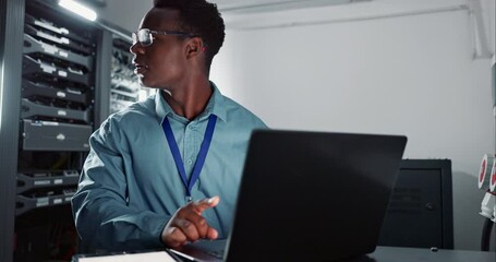 Canvas Print - Man, laptop and coding in server room as software engineer and information technology in data centre. Developer, analysis and happy on computer for work and it infrastructure for network programming