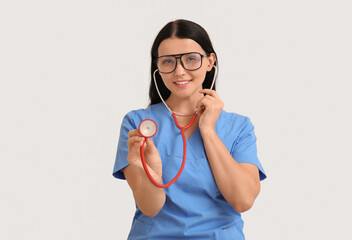 Wall Mural - Female doctor on light background