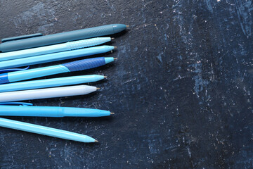 Wall Mural - Pens on blue grunge background