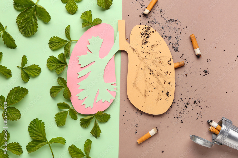 Paper lungs with cigarettes and leaves on color background