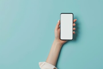 A female person holding a mobile phone with blank white display screen on a soft blue background