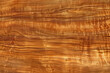 © Russell - The texture of Koa wood grain showcases a striking interplay of swirling, intricate patterns in shades ranging from golden to dark brown, giving it a uniquely luxurious and exotic appearance