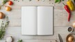 © KanitChurem - Blank recipe book on wooden table surrounded by fresh vegetables and kitchen utensils ready for cooking inspiration and creative recipes.