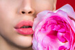 © Yevhen - Women's lips and pink flower. Woman with rose flower. Closeup sexy female lips with pink lipstick. Close-up female lips with pink flower. Closeup sexy female lip with red color lipstick