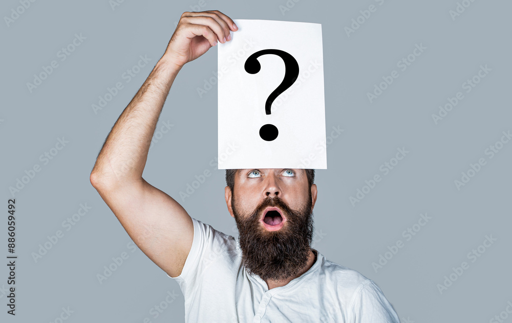 Thinking man with question mark on gray background. Man with question mark on forehead. Paper notes with question marks. Beard man question mark in head, solution problems