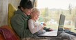 © MagicDavid/peopleimages.com - Funny, camping and laptop with family in nature for watching movie, streaming and peace. Adventure, travel and vacation with mother and daughter in van for road trip, bonding and film subscription