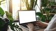 © Creative Art7 - Close up of hands typing on a laptop with a blank white screen, a woman working at home in her office with a modern interior